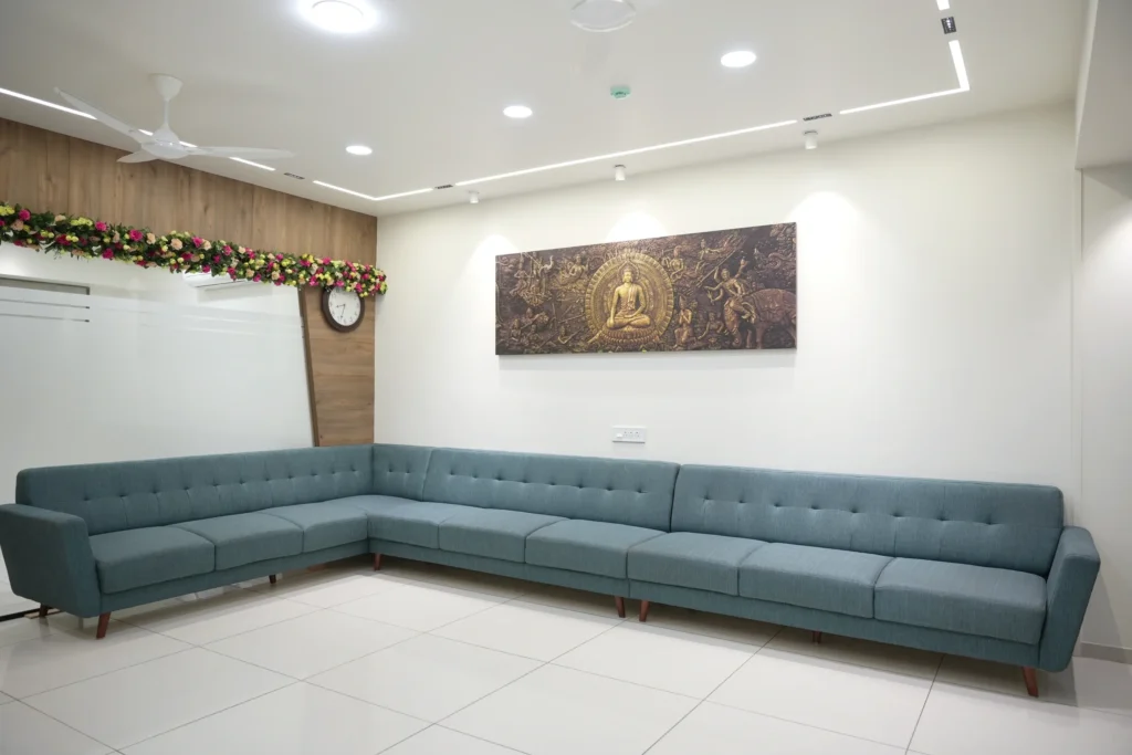 The clinic waiting area with a long sofa, tiled floor and a framed artwork on the wall