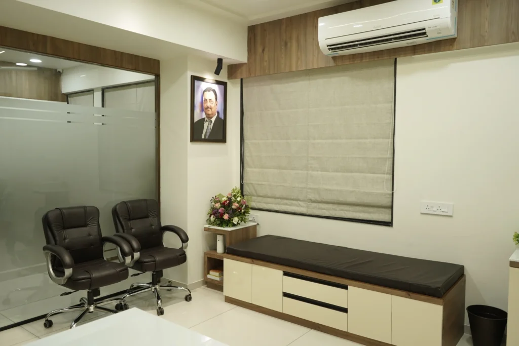 A consultation room with two chairs and an examination couch