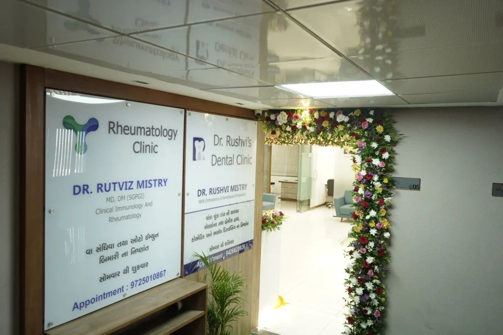 The clinic entrance with the name boards and a flower-decorated doorway