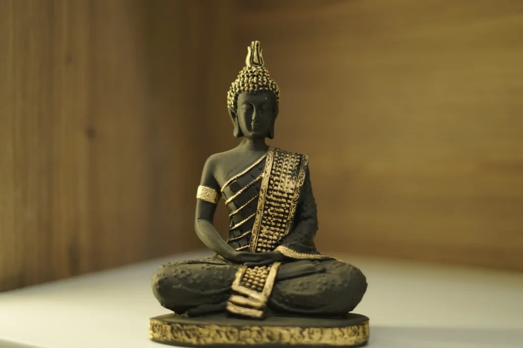 A bronze Buddha statue in a meditation pose, part of the clinic's decor